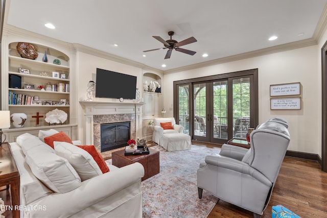 12209 Preston Landing Way, Knoxville, TN 37922 - living room with a fireplace, a ceiling fan, ornamental molding, built in shelves, and wood finished floors