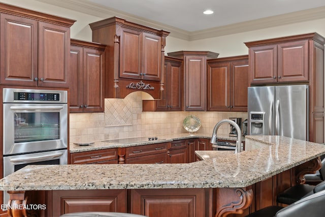 12209 Preston Landing Way, Knoxville, TN 37922 - kitchen featuring appliances with stainless steel finishes, a breakfast bar, light stone countertops, backsplash, and crown molding