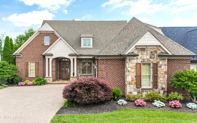 12209 Preston Landing Way, Knoxville, TN 37922 - view of front facade featuring stone siding, roof with shingles, brick siding, and decorative driveway