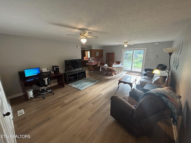 1790 Coon Hunt Rd, Baxter, TN 38544 - living room with ceiling fan, wood finished floors, and a textured ceiling