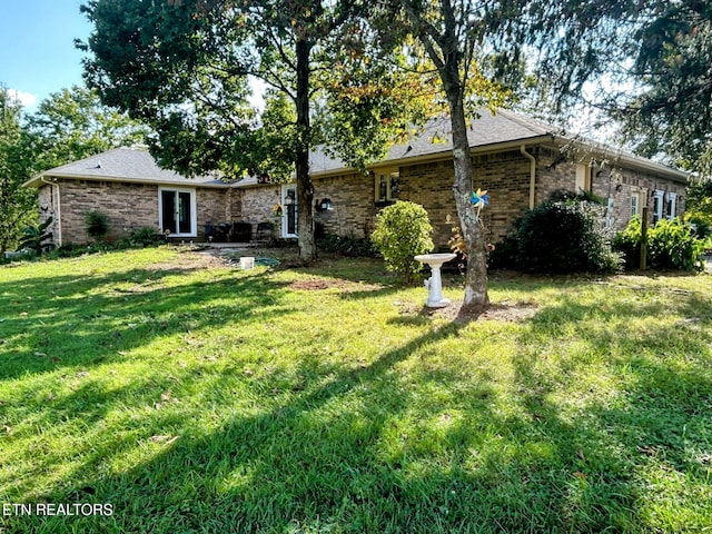 1790 Coon Hunt Rd, Baxter, TN 38544 - rear view of house with a yard and brick siding