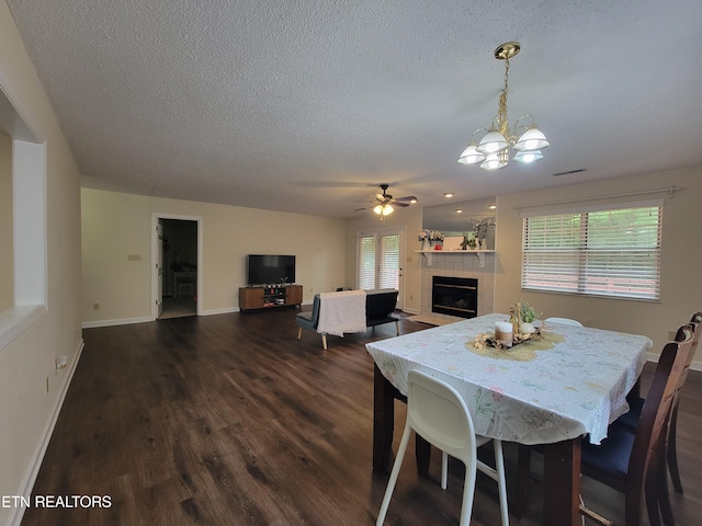 237 Camelot Ct, Knoxville, TN 37922 - dining room featuring a tiled fireplace, dark wood-type flooring, a textured ceiling, plenty of natural light, and a chandelier