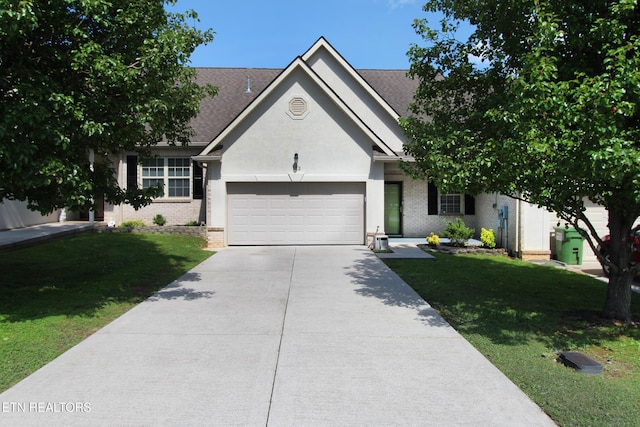 122 Dayflower Way, Maynardville, TN 37807 - ranch-style home with an attached garage, driveway, brick siding, and a front lawn