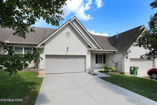 122 Dayflower Way, Maynardville, TN 37807 - ranch-style house featuring an attached garage, driveway, a shingled roof, and a front lawn