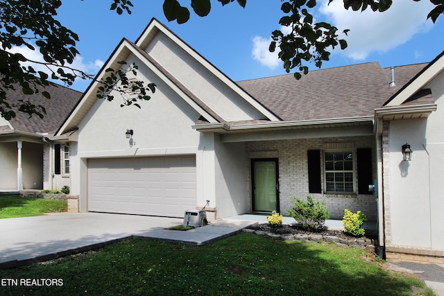 122 Dayflower Way, Maynardville, TN 37807 - view of front of property with a garage, concrete driveway, brick siding, a shingled roof, and stucco siding