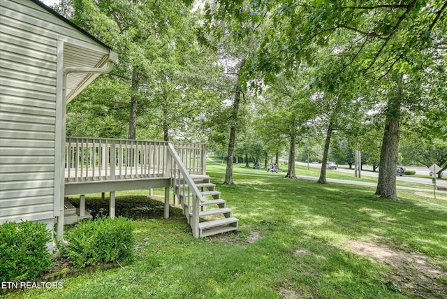 7000 Big Horn Dr Unit C-11, Crossville, TN 38572 - view of green lawn featuring a deck, view of wooded area, and stairs