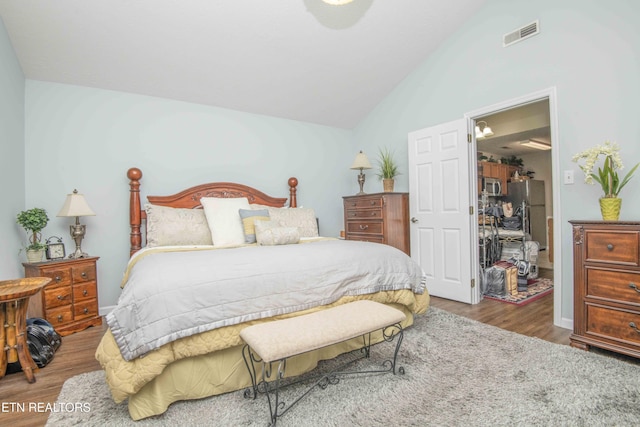 5632 Libby Way, Knoxville, TN 37924 - bedroom with lofted ceiling, wood finished floors, and freestanding refrigerator
