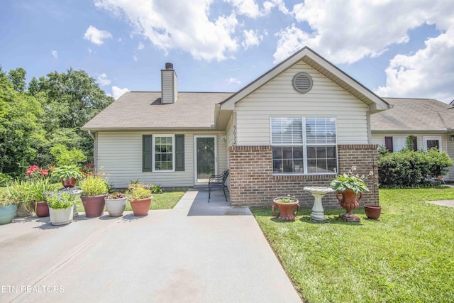 5632 Libby Way, Knoxville, TN 37924 - view of front of home with a front yard, brick siding, a chimney, and a patio