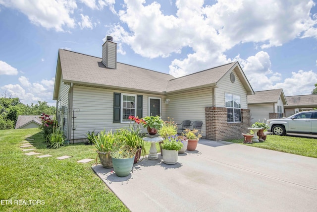 5632 Libby Way, Knoxville, TN 37924 - view of front of property featuring a patio, a chimney, a front yard, and brick siding
