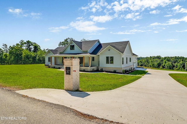 320 Ridge Ln, Monterey, TN 38574 - modern inspired farmhouse featuring board and batten siding, a front yard, concrete driveway, covered porch, and a shingled roof
