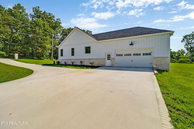 320 Ridge Ln, Monterey, TN 38574 - view of side of property featuring brick siding, driveway, a yard, an attached garage, and a shingled roof