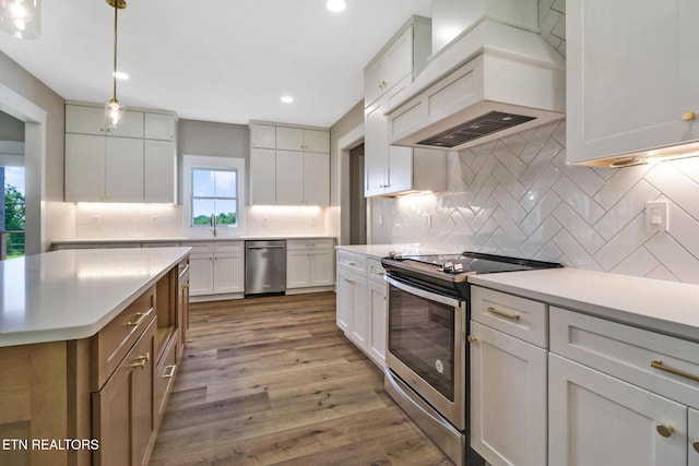 320 Ridge Ln, Monterey, TN 38574 - kitchen with appliances with stainless steel finishes, custom range hood, backsplash, light countertops, and dark wood-style flooring
