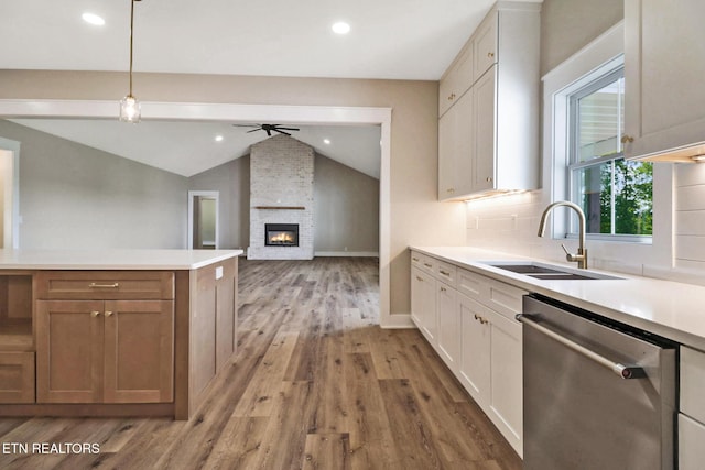 320 Ridge Ln, Monterey, TN 38574 - kitchen featuring stainless steel dishwasher, vaulted ceiling, light wood-style flooring, a ceiling fan, and light countertops