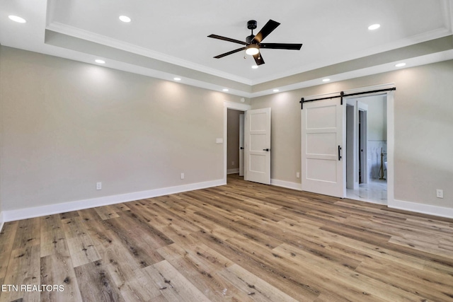 320 Ridge Ln, Monterey, TN 38574 - unfurnished bedroom with a raised ceiling, a barn door, crown molding, wood finished floors, and recessed lighting