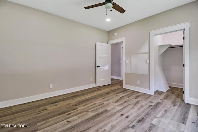 320 Ridge Ln, Monterey, TN 38574 - unfurnished bedroom with wood finished floors, ceiling fan, recessed lighting, a walk in closet, and a closet