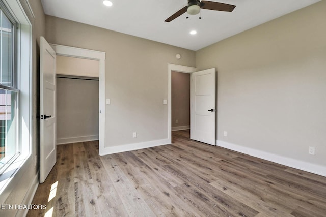 320 Ridge Ln, Monterey, TN 38574 - unfurnished bedroom with light wood-type flooring, a spacious closet, recessed lighting, ceiling fan, and a closet