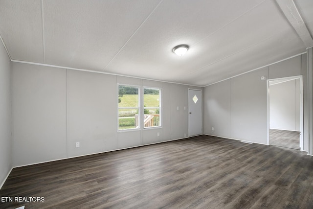 6952 Cottonport Rd, Decatur, TN 37322 - empty room featuring dark wood-type flooring and vaulted ceiling
