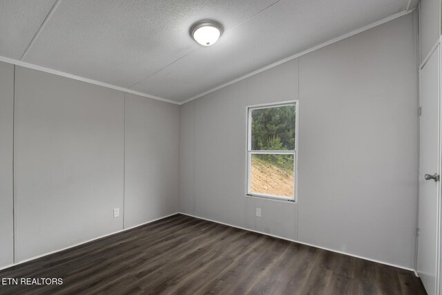 6952 Cottonport Rd, Decatur, TN 37322 - empty room featuring crown molding, lofted ceiling, dark wood finished floors, and a textured ceiling