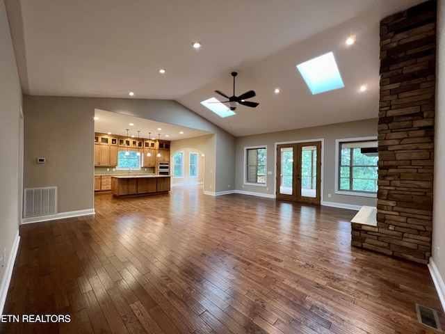 2005 River Mist Cir, New Market, TN 37820 - unfurnished living room with a skylight, dark wood-type flooring, lofted ceiling, ceiling fan, and recessed lighting