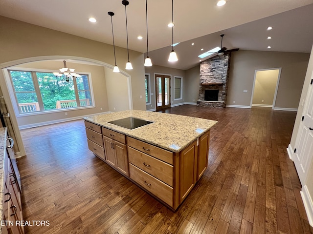 2005 River Mist Cir, New Market, TN 37820 - kitchen with black electric stovetop, a fireplace, arched walkways, a chandelier, and ceiling fan