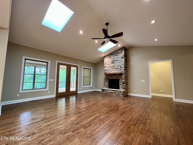 2005 River Mist Cir, New Market, TN 37820 - unfurnished living room featuring a skylight, ceiling fan, dark wood-type flooring, a fireplace, and lofted ceiling