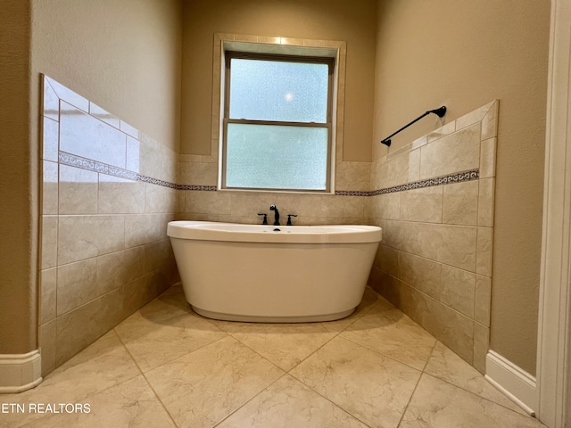 2005 River Mist Cir, New Market, TN 37820 - full bathroom featuring a freestanding tub, a wainscoted wall, and marble finish floors