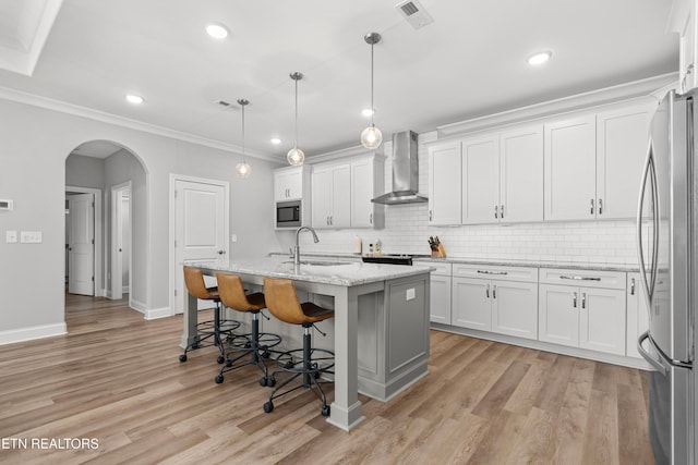 402 Sycamore Pl, Loudon, TN 37774 - kitchen featuring wall chimney range hood, appliances with stainless steel finishes, backsplash, white cabinets, and recessed lighting
