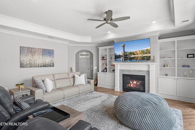 402 Sycamore Pl, Loudon, TN 37774 - living area with a raised ceiling, a ceiling fan, wood finished floors, a glass covered fireplace, and ornamental molding