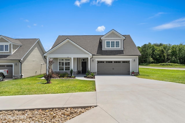 402 Sycamore Pl, Loudon, TN 37774 - craftsman-style house with concrete driveway, a front lawn, a garage, stone siding, and roof with shingles