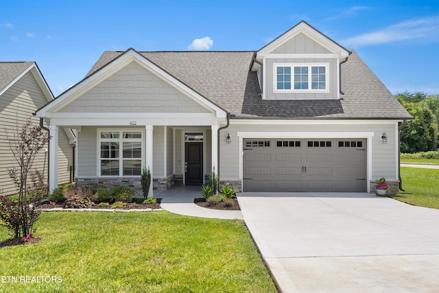 402 Sycamore Pl, Loudon, TN 37774 - craftsman house featuring a front lawn, driveway, board and batten siding, and stone siding