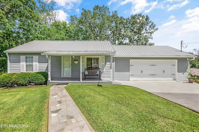 522 N Houston St, Maryville, TN 37801 - ranch-style house with a garage, driveway, a front lawn, a porch, and a metal roof