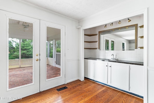 824 W Woodchase Rd, Knoxville, TN 37934 - kitchen featuring dark countertops, decorative backsplash, wood finished floors, crown molding, and white cabinets