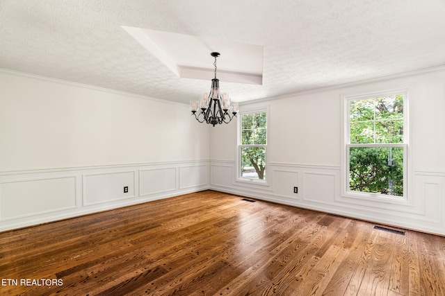 824 W Woodchase Rd, Knoxville, TN 37934 - empty room featuring a chandelier, wood finished floors, a textured ceiling, crown molding, and wainscoting