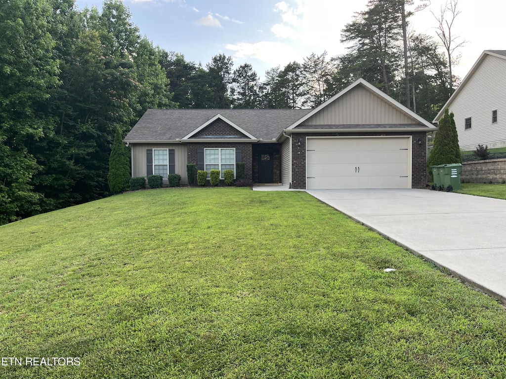 6933 Harvest Grove Ln, Knoxville, TN 37918 - single story home featuring brick siding, an attached garage, concrete driveway, and a front lawn