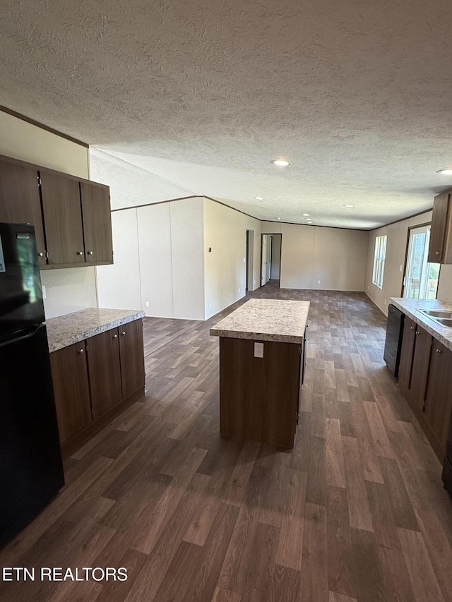 1684 Shields Dr, Morristown, TN 37814 - kitchen with freestanding refrigerator, dark wood-type flooring, open floor plan, dark brown cabinets, and a textured ceiling