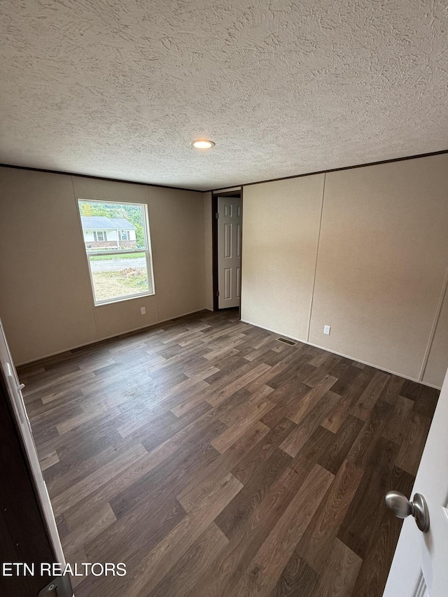1684 Shields Dr, Morristown, TN 37814 - spare room with dark wood-type flooring and a textured ceiling
