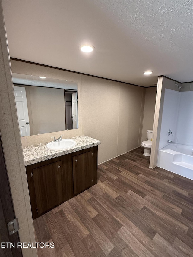 1684 Shields Dr, Morristown, TN 37814 - bathroom featuring vanity, wood finished floors, recessed lighting, tub / shower combination, and a textured ceiling