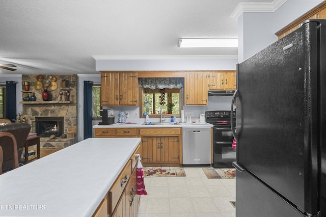122 Glenwood Dr, Crossville, TN 38555 - kitchen featuring black appliances, under cabinet range hood, light countertops, crown molding, and a fireplace