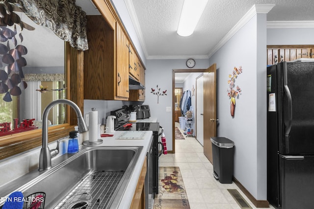 122 Glenwood Dr, Crossville, TN 38555 - kitchen featuring freestanding refrigerator, stainless steel range with electric stovetop, a textured ceiling, under cabinet range hood, and light tile patterned floors