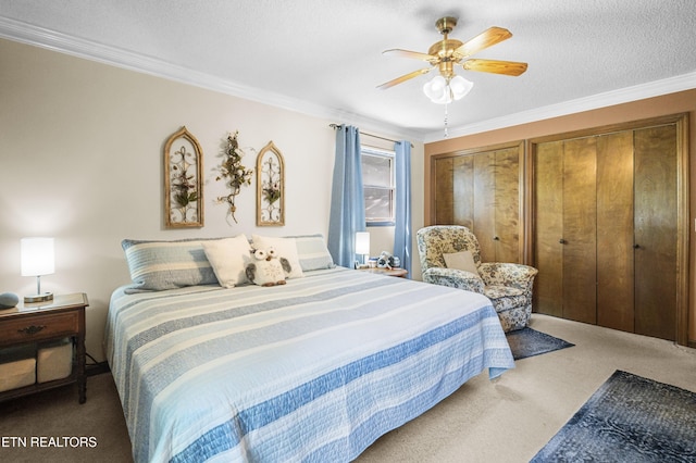122 Glenwood Dr, Crossville, TN 38555 - bedroom featuring carpet floors, ornamental molding, a ceiling fan, and two closets