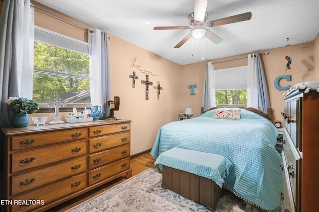 122 Glenwood Dr, Crossville, TN 38555 - bedroom featuring wood finished floors, a textured ceiling, and ceiling fan