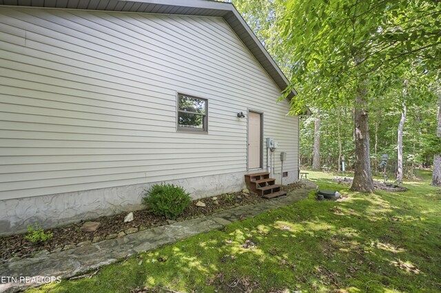 122 Glenwood Dr, Crossville, TN 38555 - rear view of property featuring entry steps and a lawn