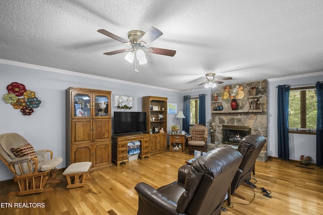 122 Glenwood Dr, Crossville, TN 38555 - living room with a textured ceiling, light wood-style floors, ceiling fan, crown molding, and a fireplace