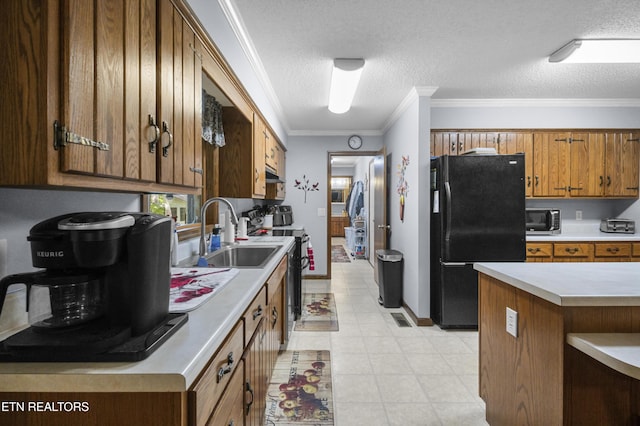 122 Glenwood Dr, Crossville, TN 38555 - kitchen with freestanding refrigerator, stainless steel microwave, range with electric stovetop, brown cabinetry, and a textured ceiling