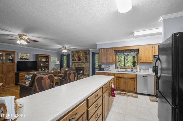 122 Glenwood Dr, Crossville, TN 38555 - kitchen with freestanding refrigerator, dishwasher, crown molding, light countertops, and a fireplace