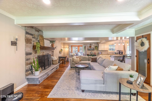 1839 Plumb Creek Cir, Knoxville, TN 37932 - living area featuring ornamental molding, dark wood-style flooring, a stone fireplace, and a textured ceiling