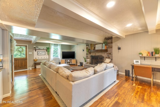 1839 Plumb Creek Cir, Knoxville, TN 37932 - living room featuring beam ceiling, hardwood / wood-style floors, a textured ceiling, a fireplace, and crown molding