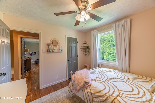 1839 Plumb Creek Cir, Knoxville, TN 37932 - bedroom featuring dark wood finished floors, a textured ceiling, and a ceiling fan