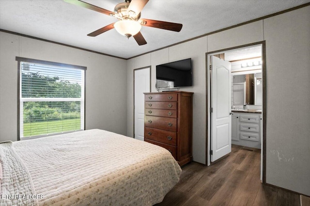 288 Forks Grove Rd, Lafollette, TN 37766 - bedroom with crown molding, dark wood-style flooring, a ceiling fan, ensuite bath, and a textured ceiling