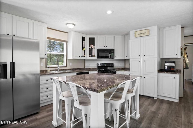 288 Forks Grove Rd, Lafollette, TN 37766 - kitchen featuring black appliances, white cabinets, dark wood-style floors, and a textured ceiling